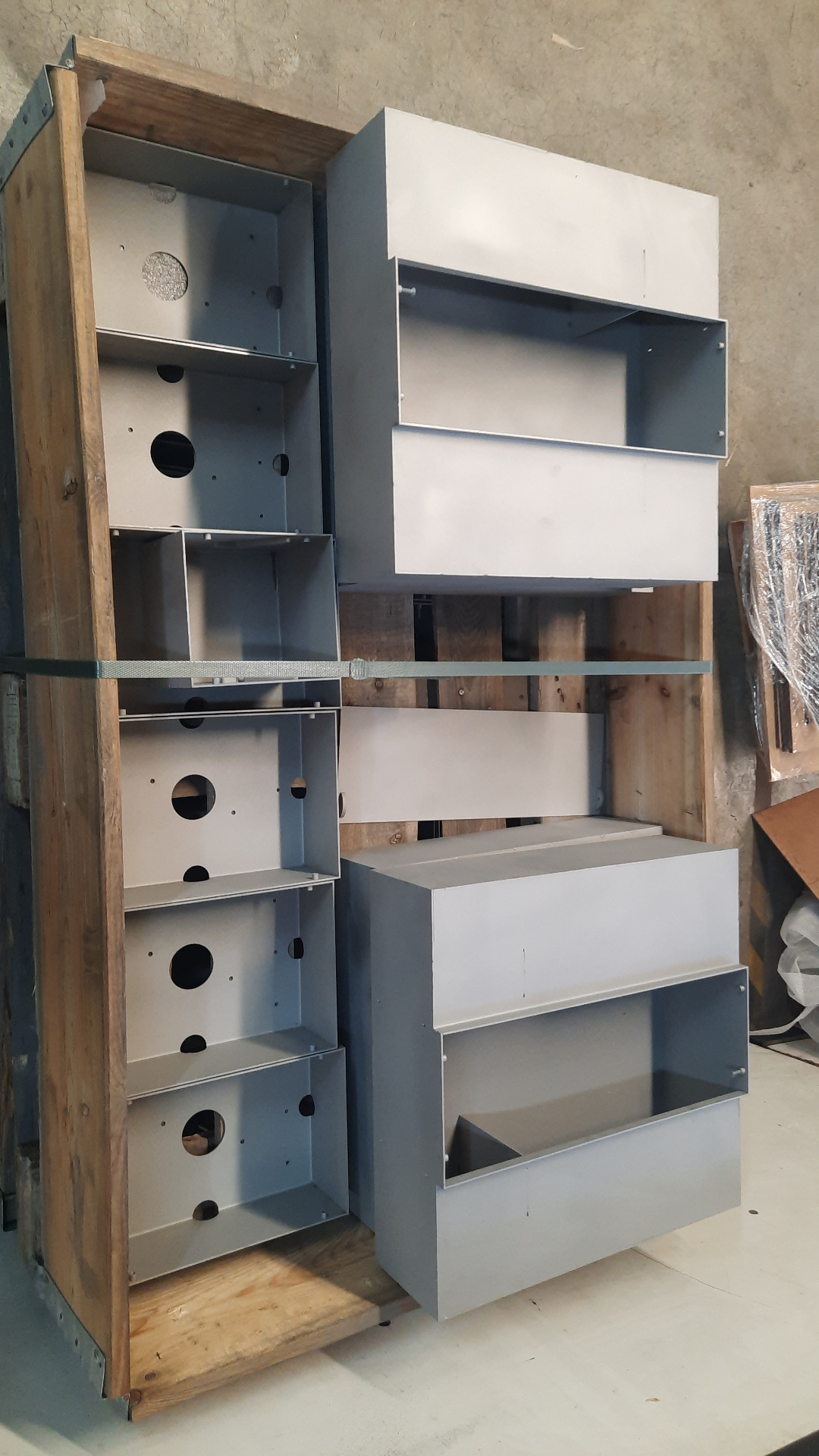 Row of HIDN enclosures with cut-outs and mounting details ready for assembly