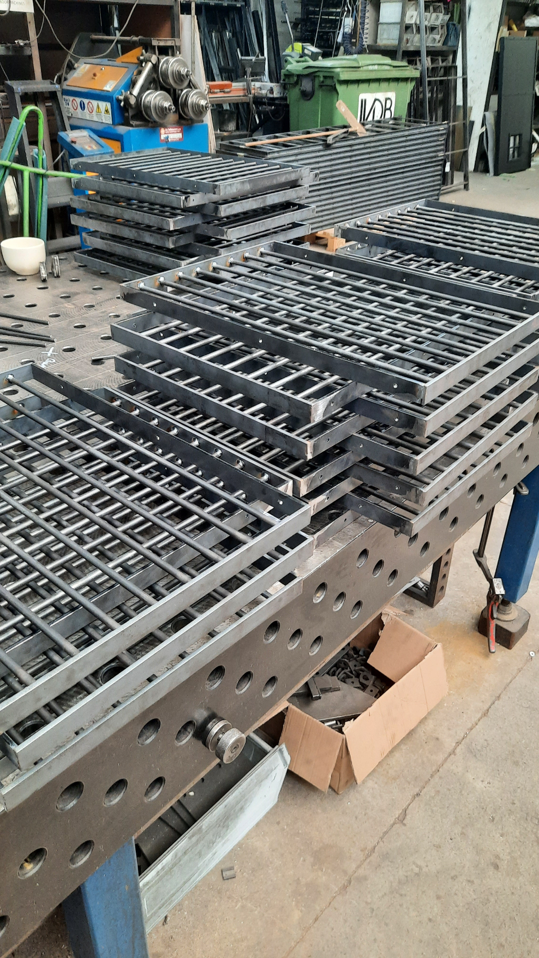 Stacked steel cabinet panels on the welding table