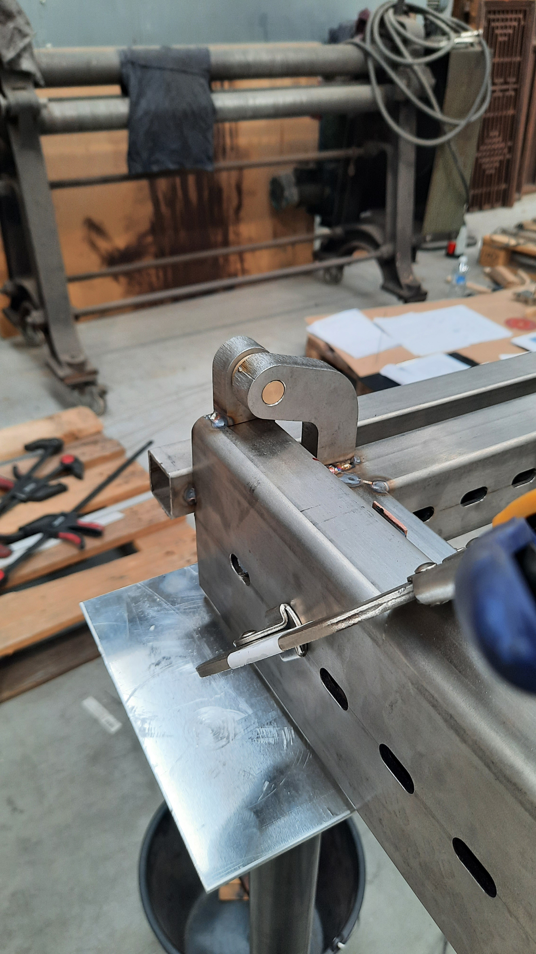Close-up of the welded hinge knuckle and bronze bushing