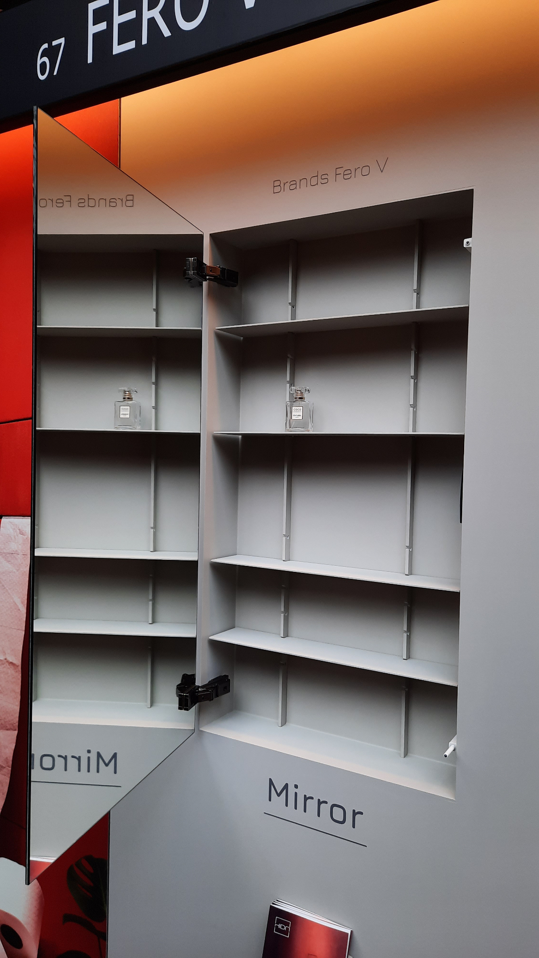 HIDN mirror cabinet open on the fair stand, revealing the interior shelving