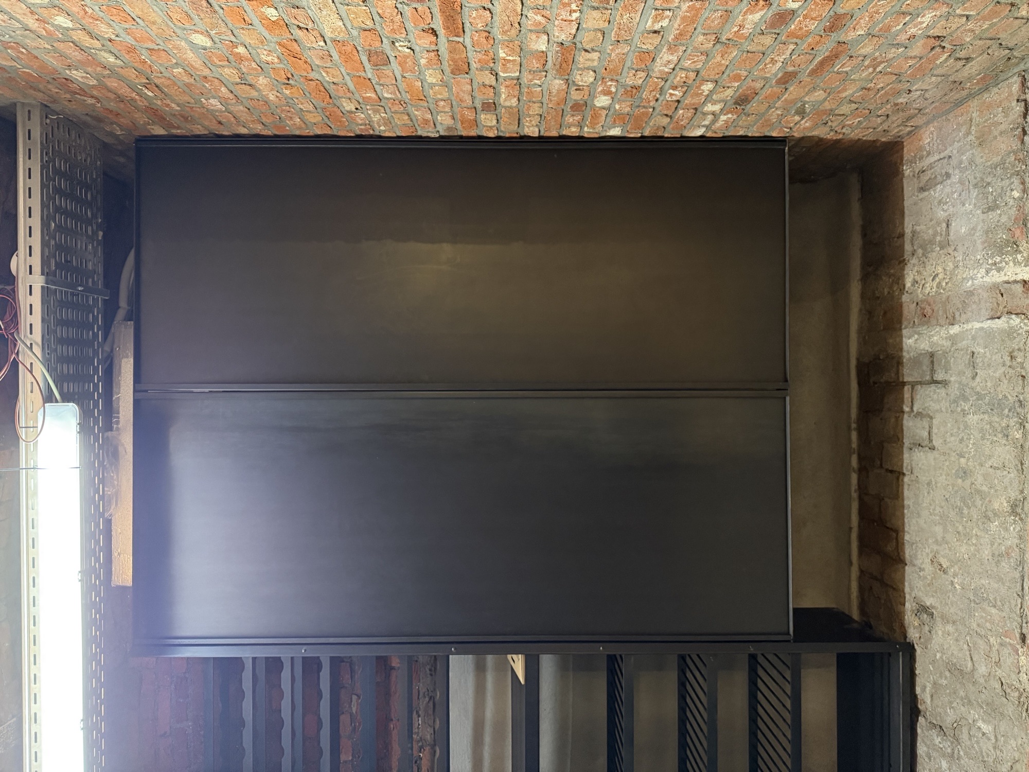 Closed steel cabinet section of the hexagonal wine cellar