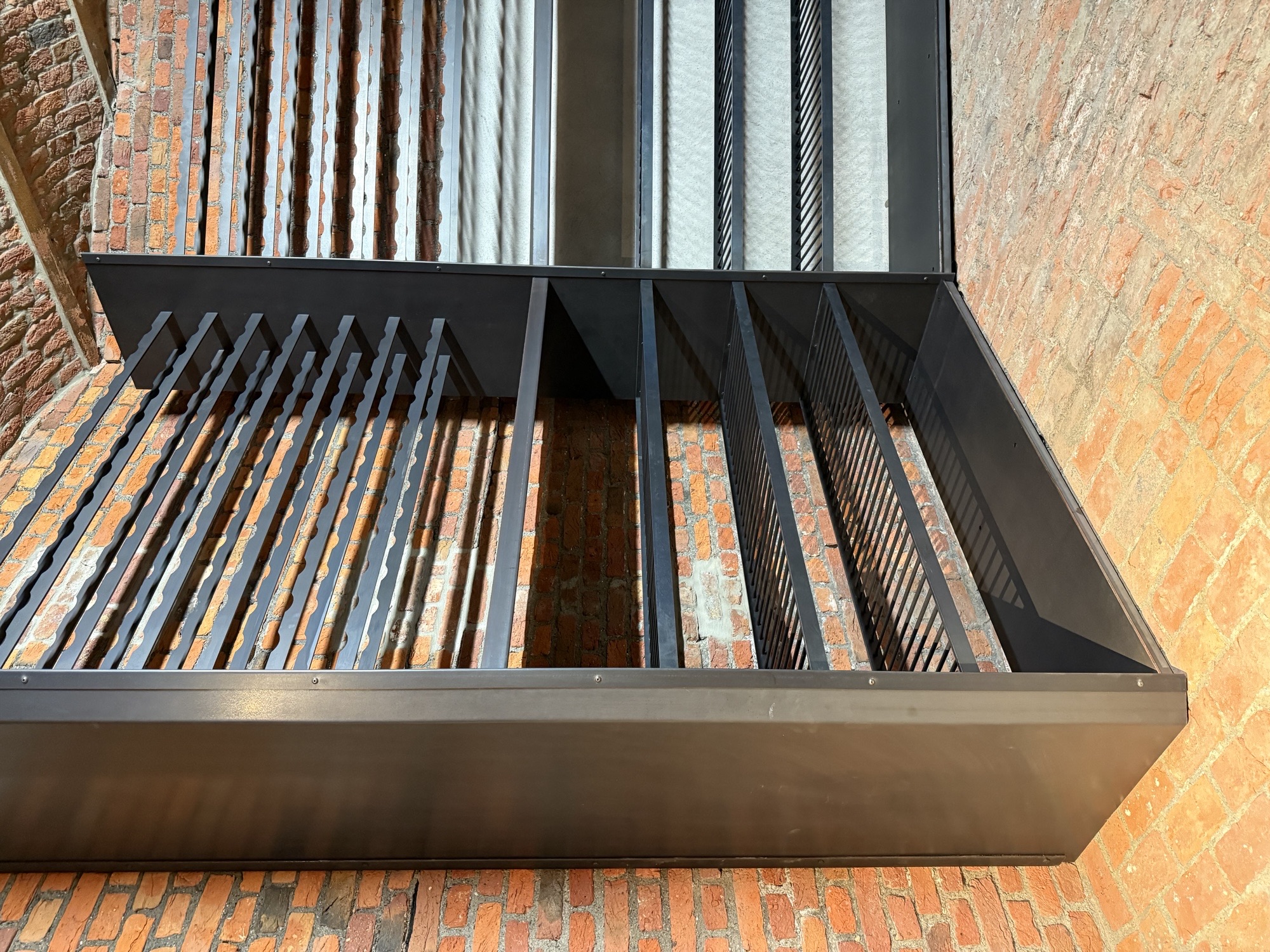 Detail of slatted bottle shelves in the hexagonal cellar