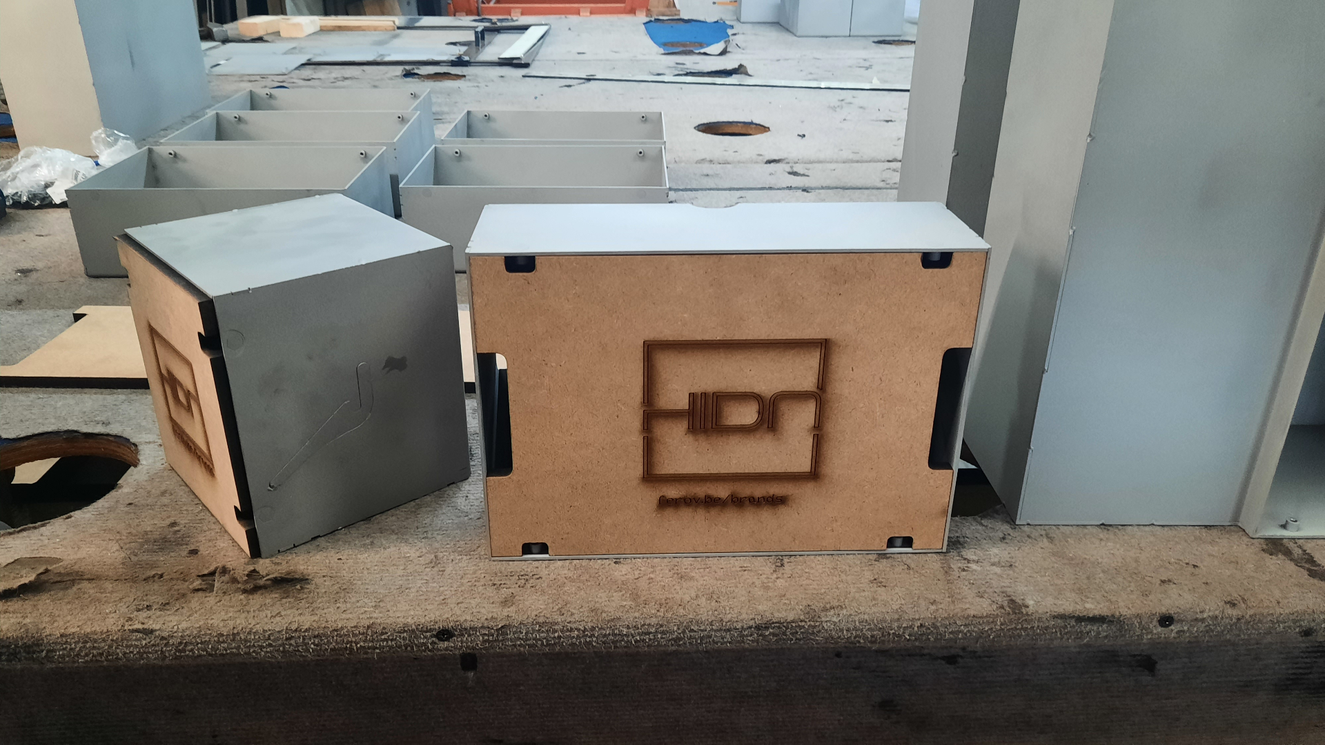 HIDN box prototypes with laser-engraved branding on MDF backing panels
